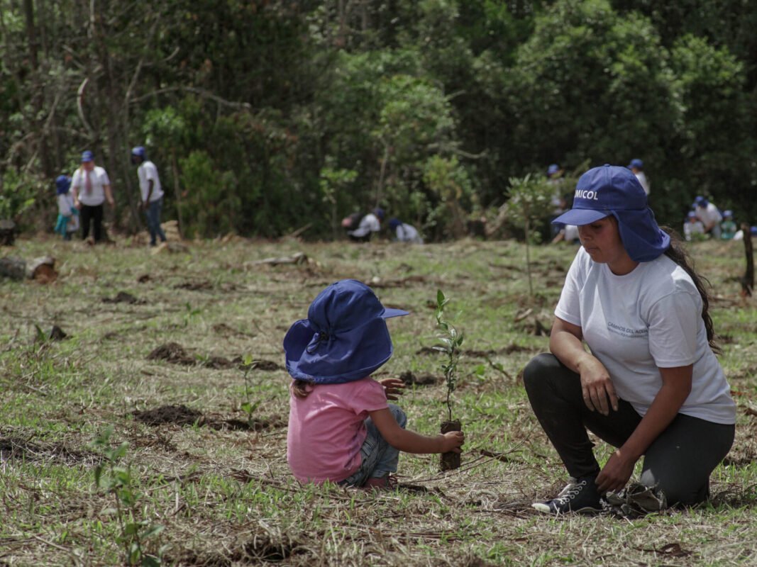 Niña y mama sembrando arbol